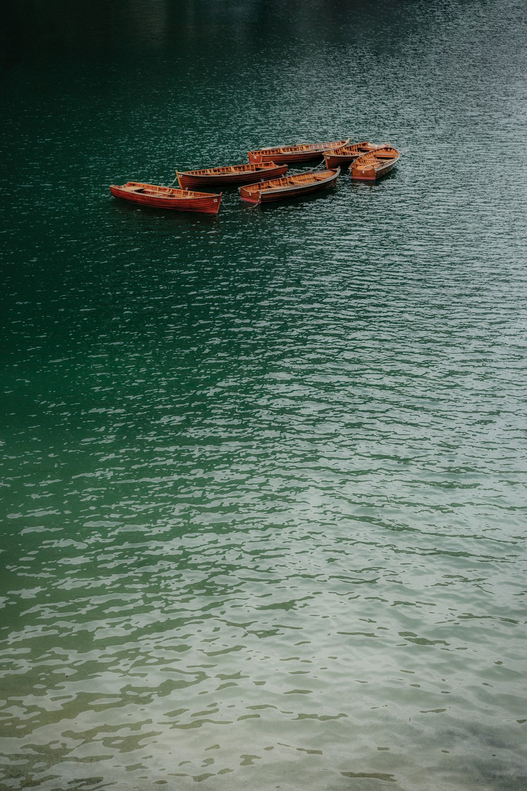 brown wooden boats on body of water during daytime