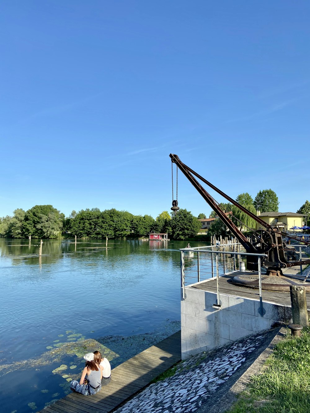 brown metal crane near body of water during daytime