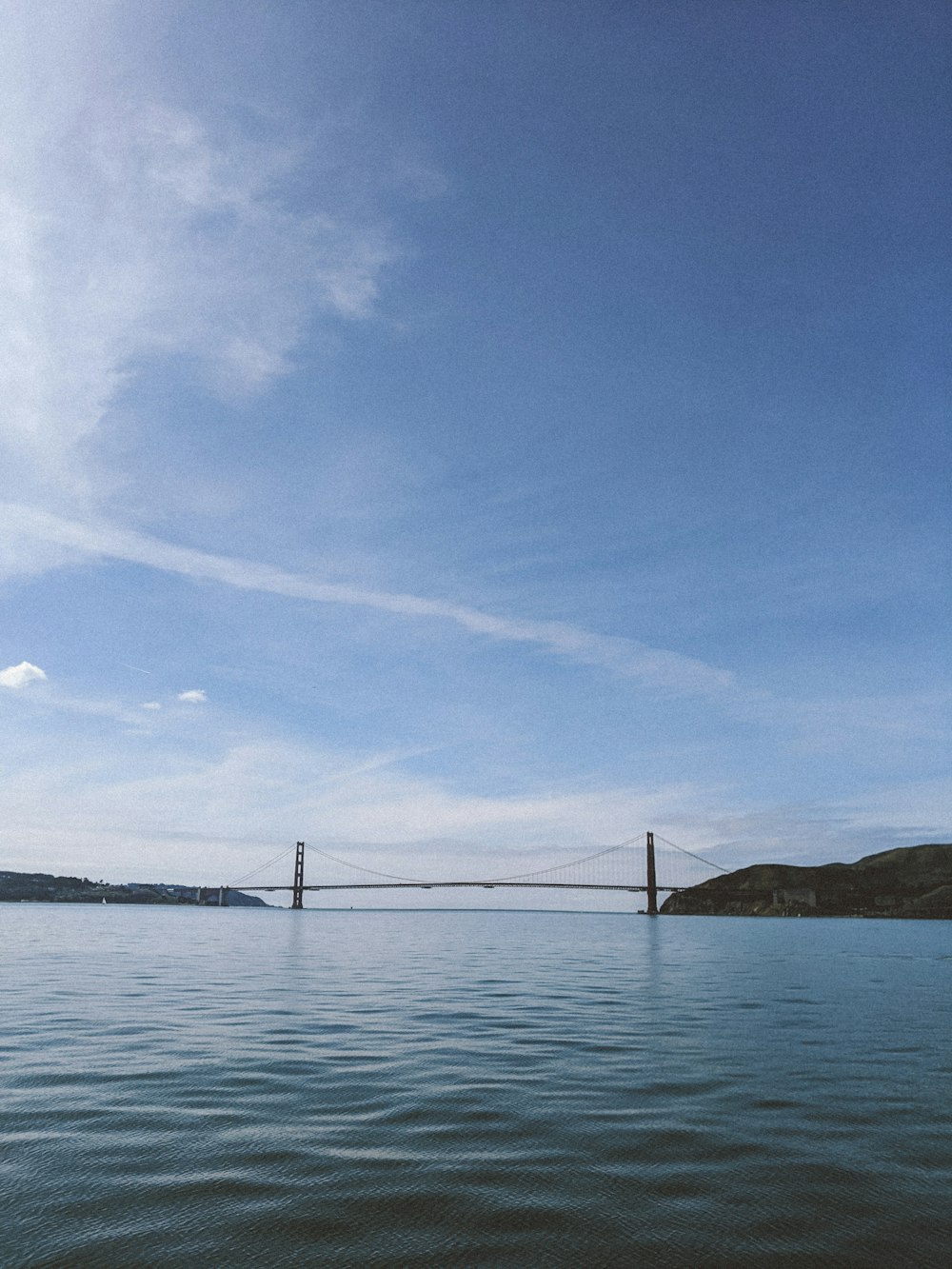 bridge over the sea under blue sky