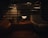 A cozy living room illuminated by a stylish modern lamp on a wooden side table.