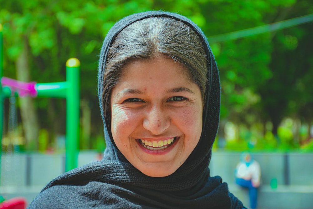 woman in black turtleneck shirt smiling