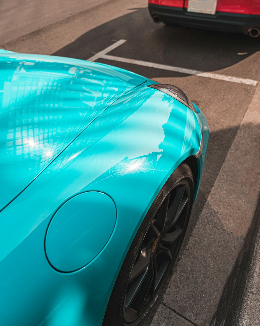 blue car on gray asphalt road