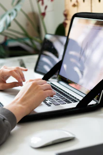 person using macbook pro on table