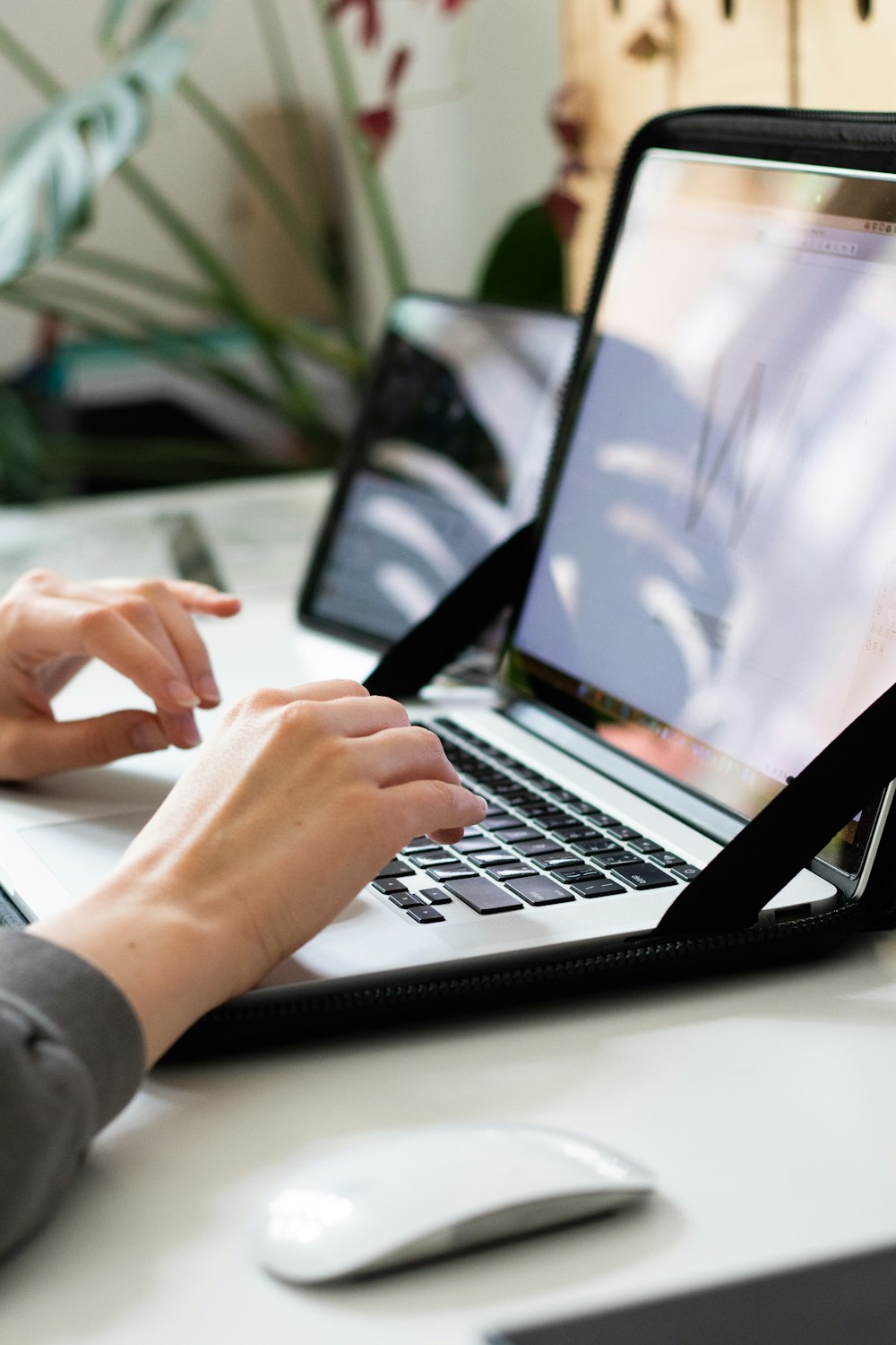 person using macbook pro on table