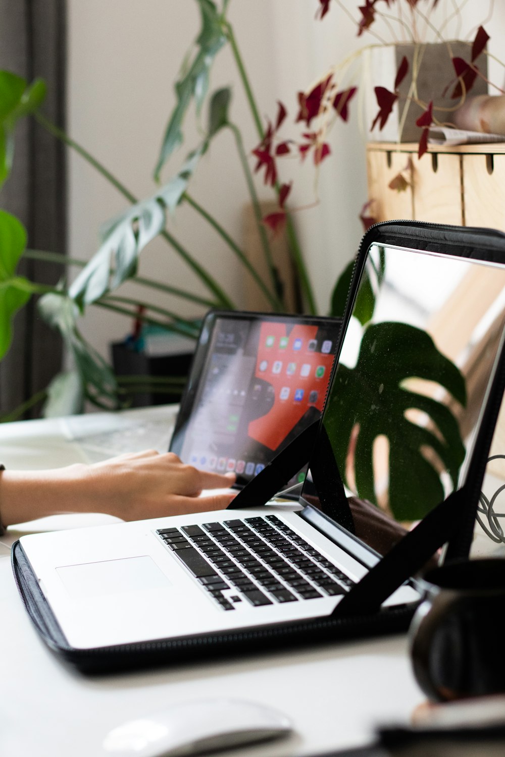 person using macbook pro on table