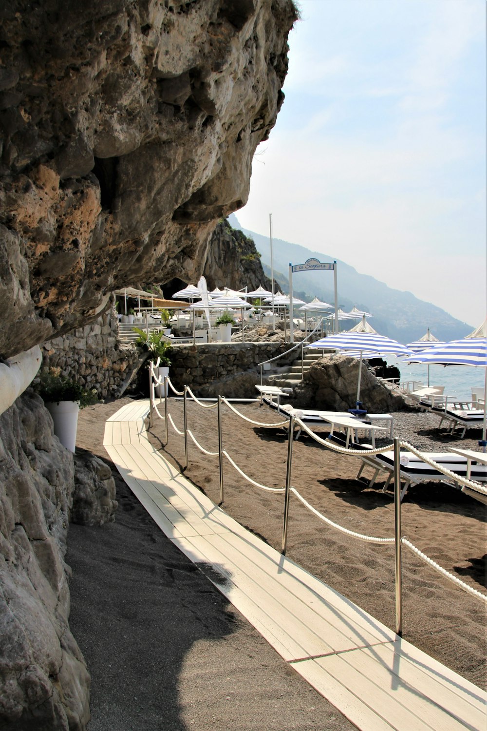 white wooden table and chairs on beach during daytime