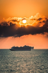 white ship on sea under blue sky during daytime