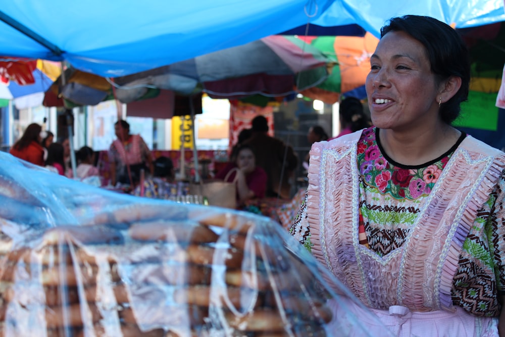 a woman standing in front of a bag of donuts