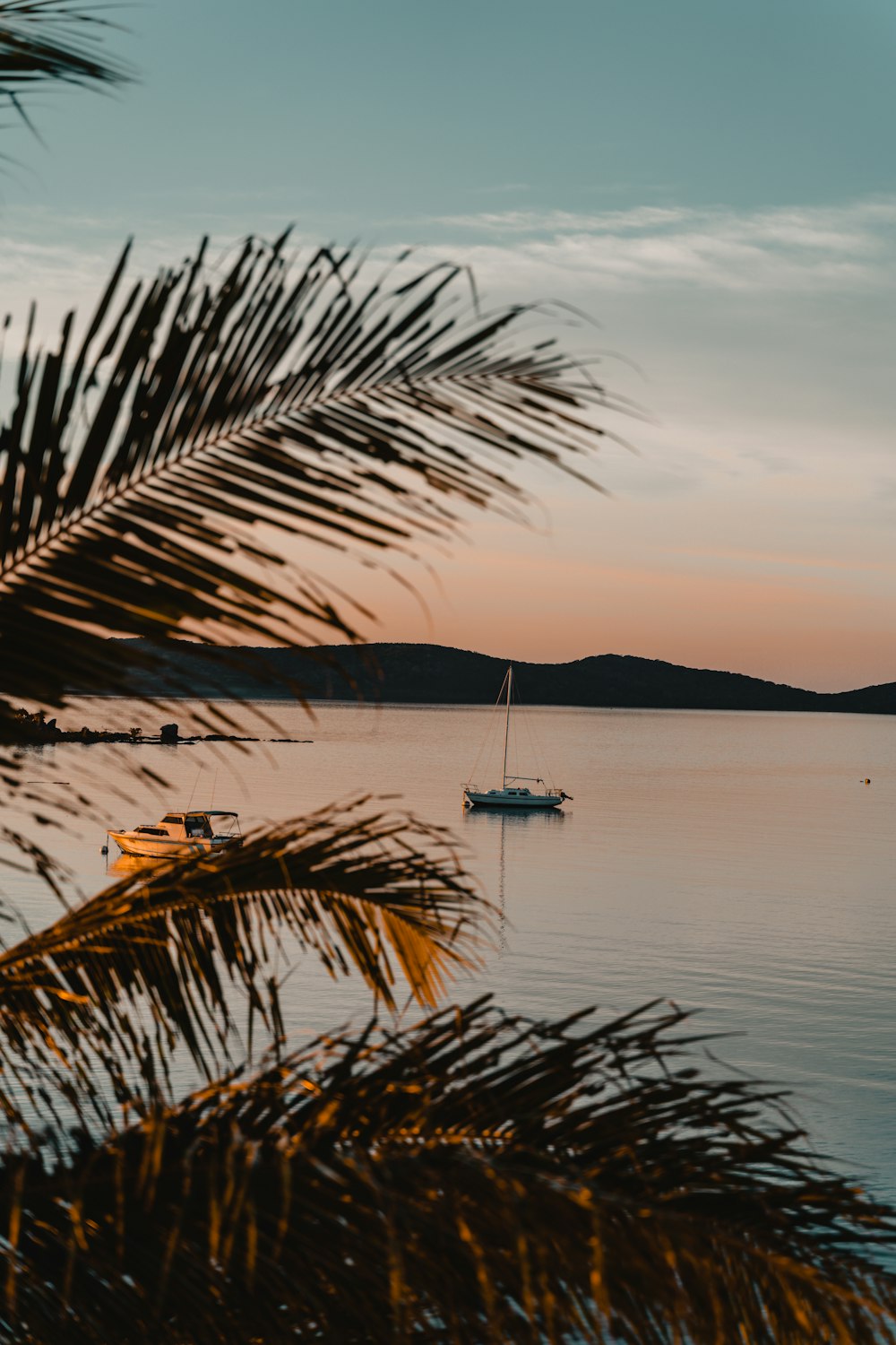 white boat on sea during sunset