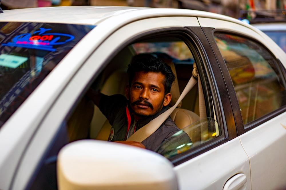 man in green shirt sitting inside car