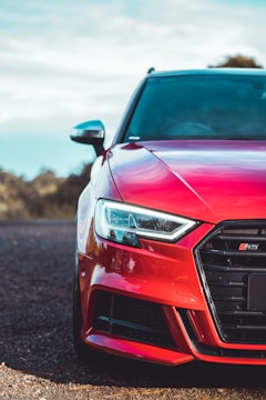 red bmw car on brown soil during daytime