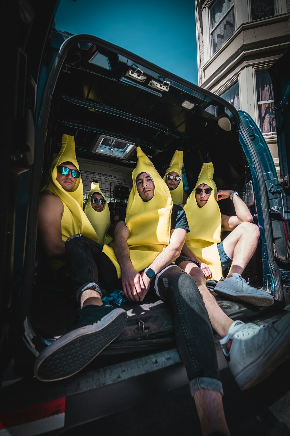 Men sitting in banana suit 