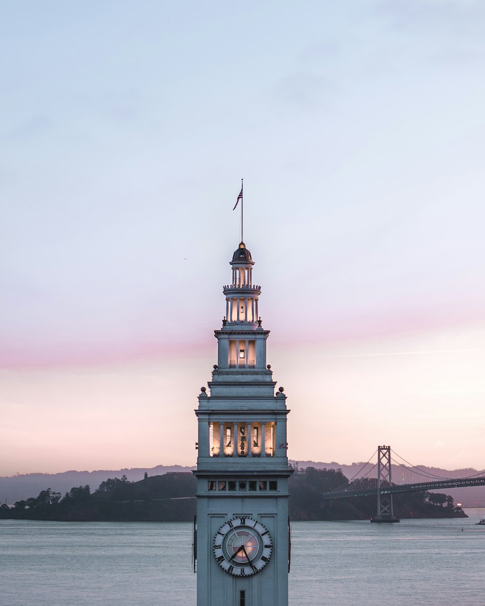 a clock tower with a flag on top of it