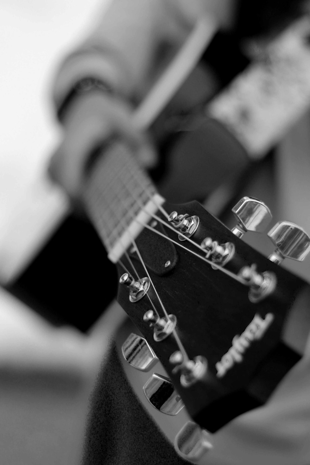 grayscale photo of acoustic guitar