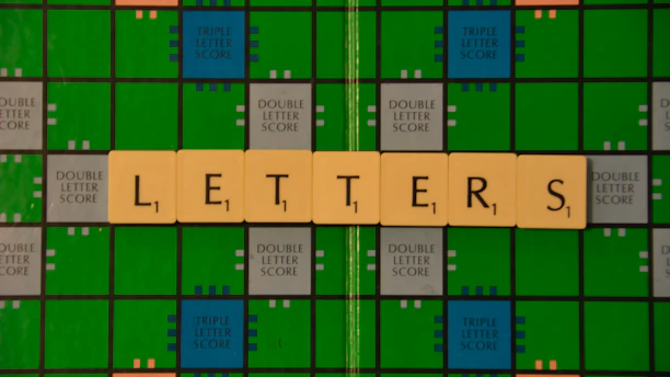A vibrant screenshot of Canuckle's word game interface showing colorful letter tiles and a partially completed word grid.