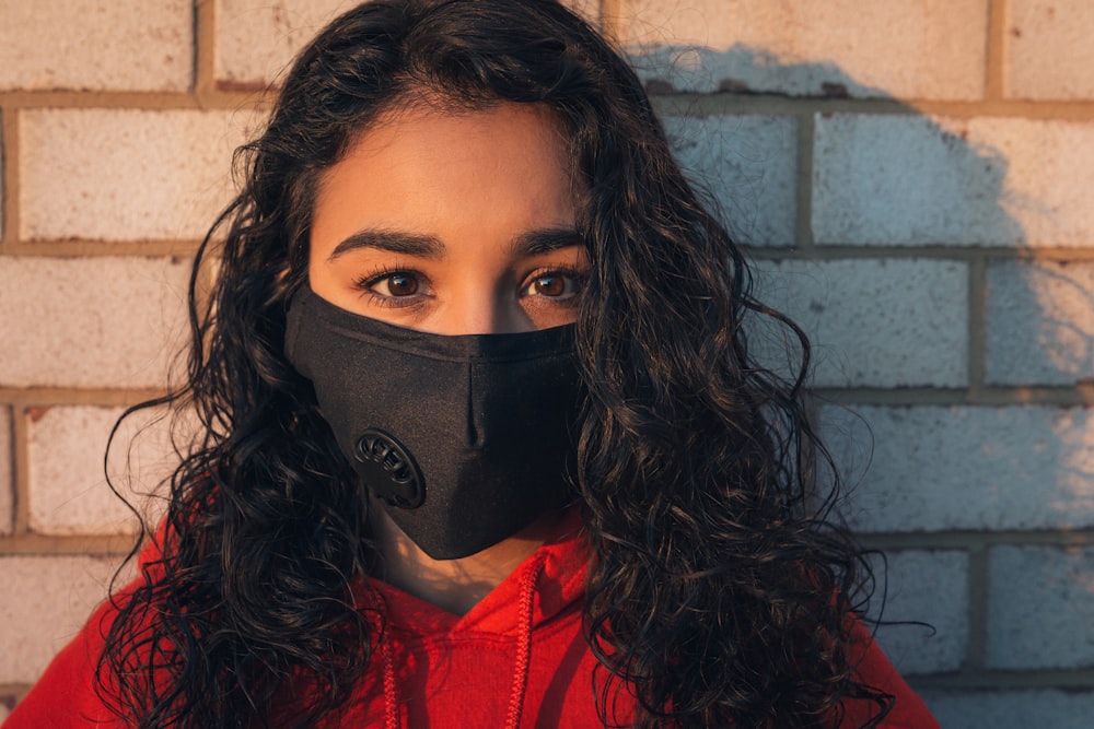 woman in red shirt wearing black mask