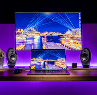 Sleek, futuristic workspace featuring dual monitors with vibrant digital designs.