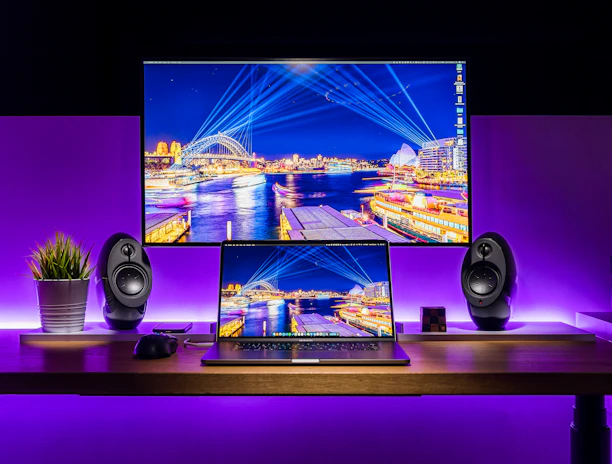 Sleek, futuristic workspace featuring dual monitors with vibrant digital designs.