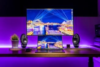 A vibrant and modern workspace with a computer and entertainment setup.