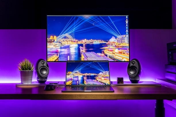 A futuristic workspace featuring glowing screens and modern technology.
