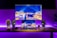 A modern workspace featuring a sleek holographic display console with vibrant visuals.