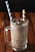 clear glass mug with white and blue striped straw