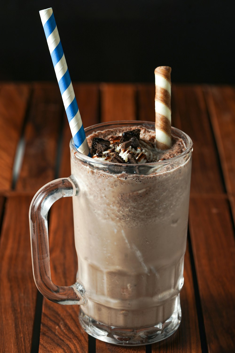 clear glass mug with white and blue striped straw