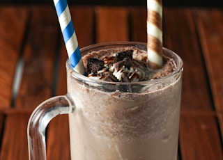 clear glass mug with white and blue striped straw