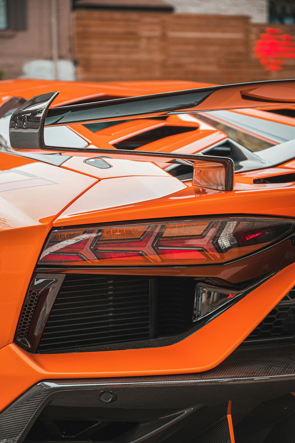 an orange sports car parked in a parking lot