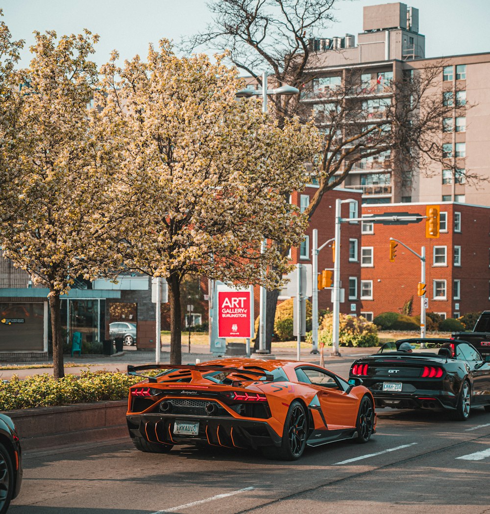 cars parked on side of the road near brown building during daytime