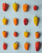 A colorful display of assorted bell peppers arranged neatly on rustic wooden crates.