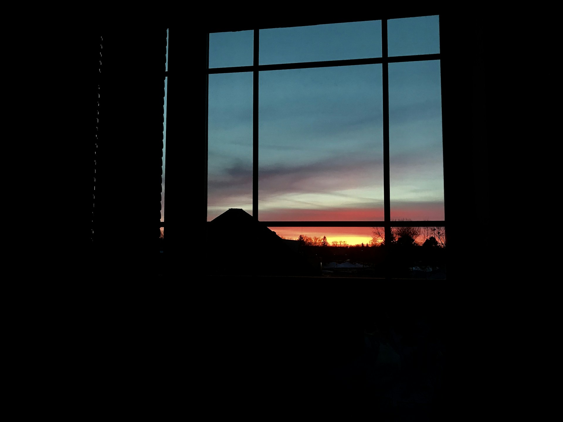 Sunset over the Saint-Laurent River as seen from the panoramic windows of the Anseau Persil chalet.