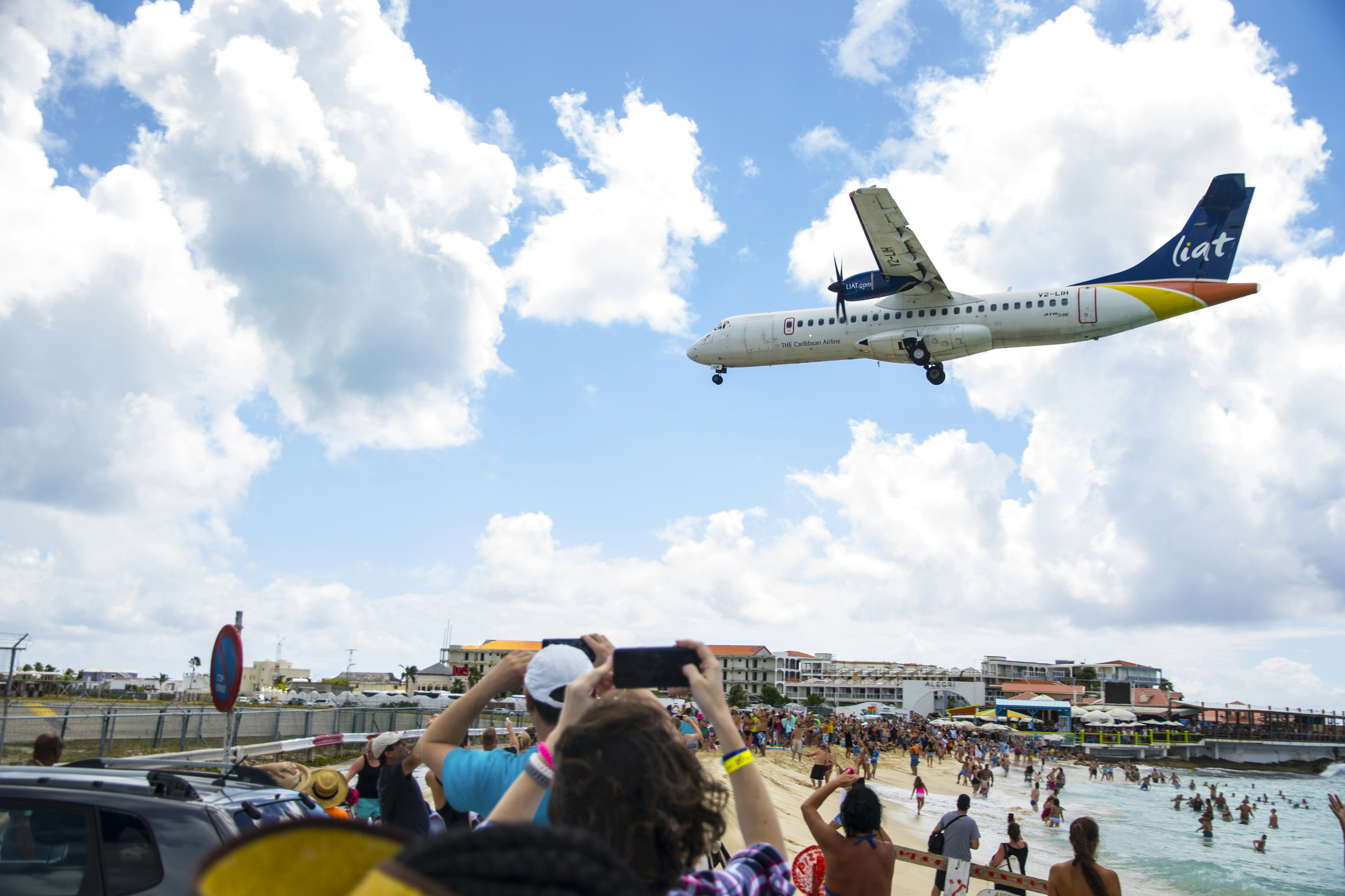 people gathering near airplane under blue sky during daytime, Beach Airport - St. Maarten