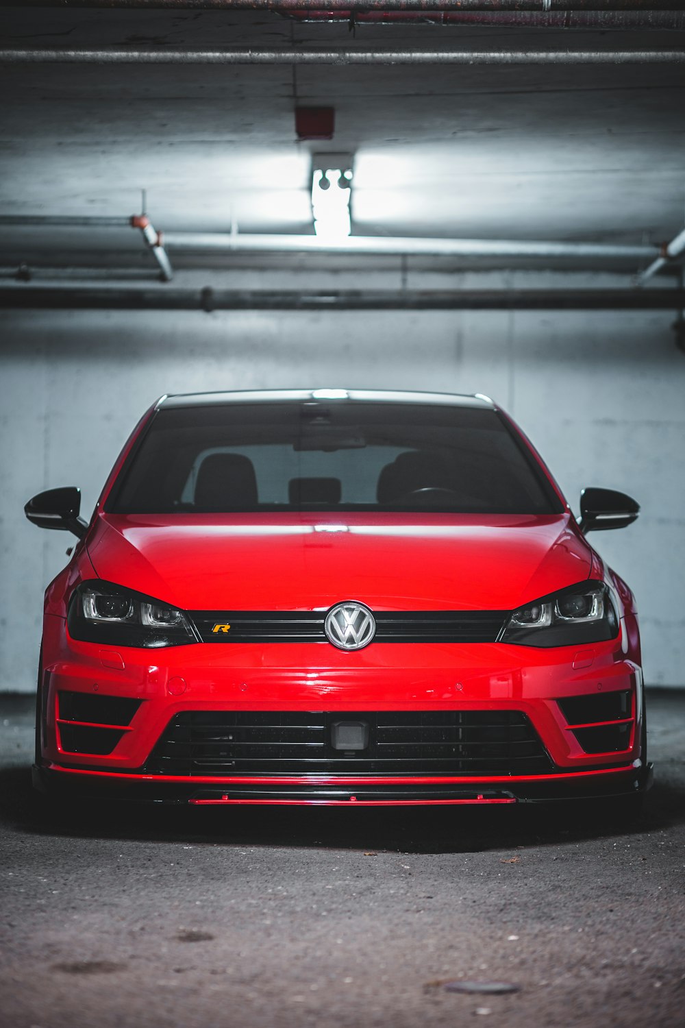 a red car parked in a parking garage