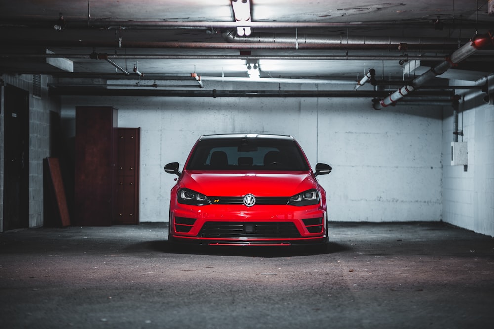 red bmw car parked in garage