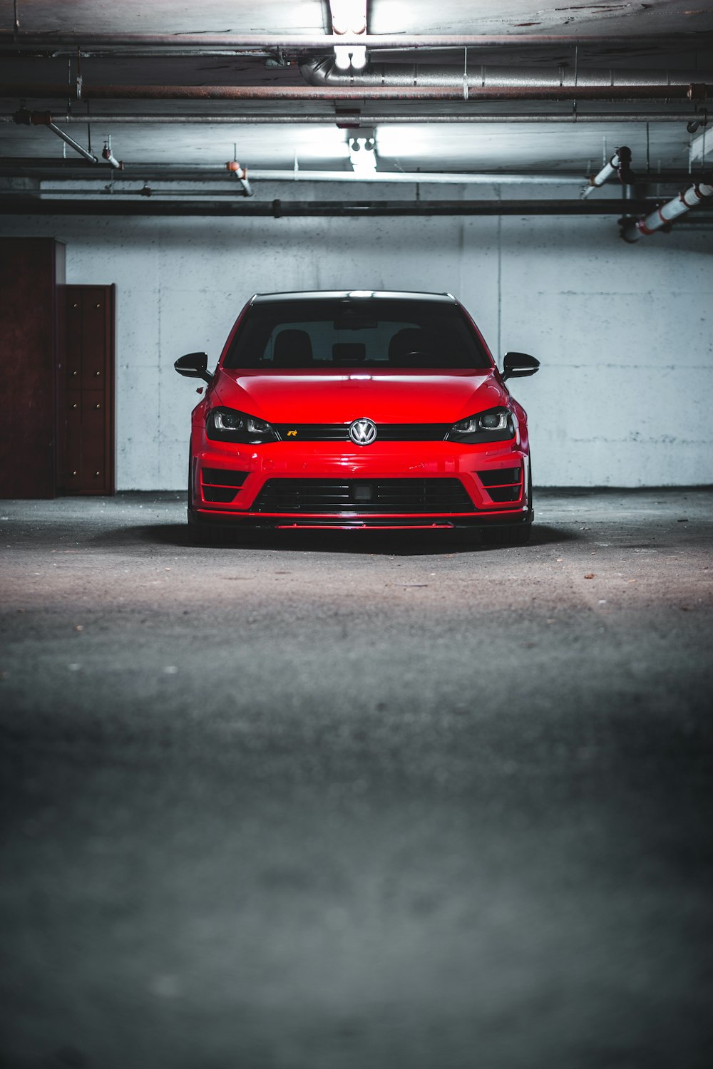 a red car parked in a parking garage