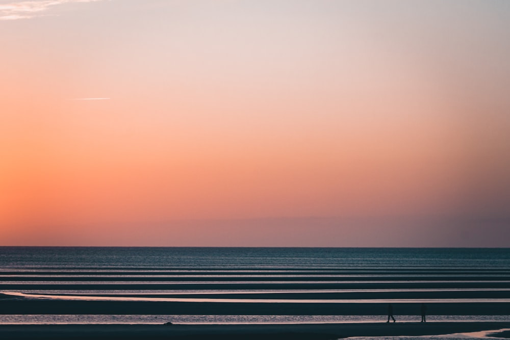 body of water during sunset