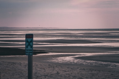 A serene beachside hotel with a pest control sign.