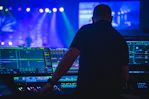 man in black t-shirt playing audio mixer