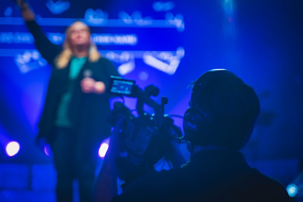 man in black shirt holding microphone