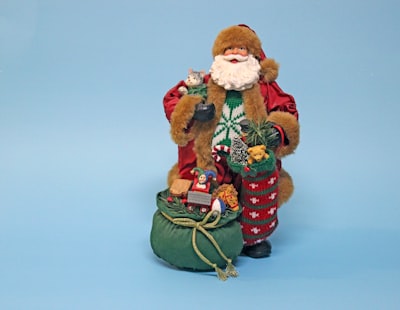 brown bear in red and brown coat figurine father christmas google meet background