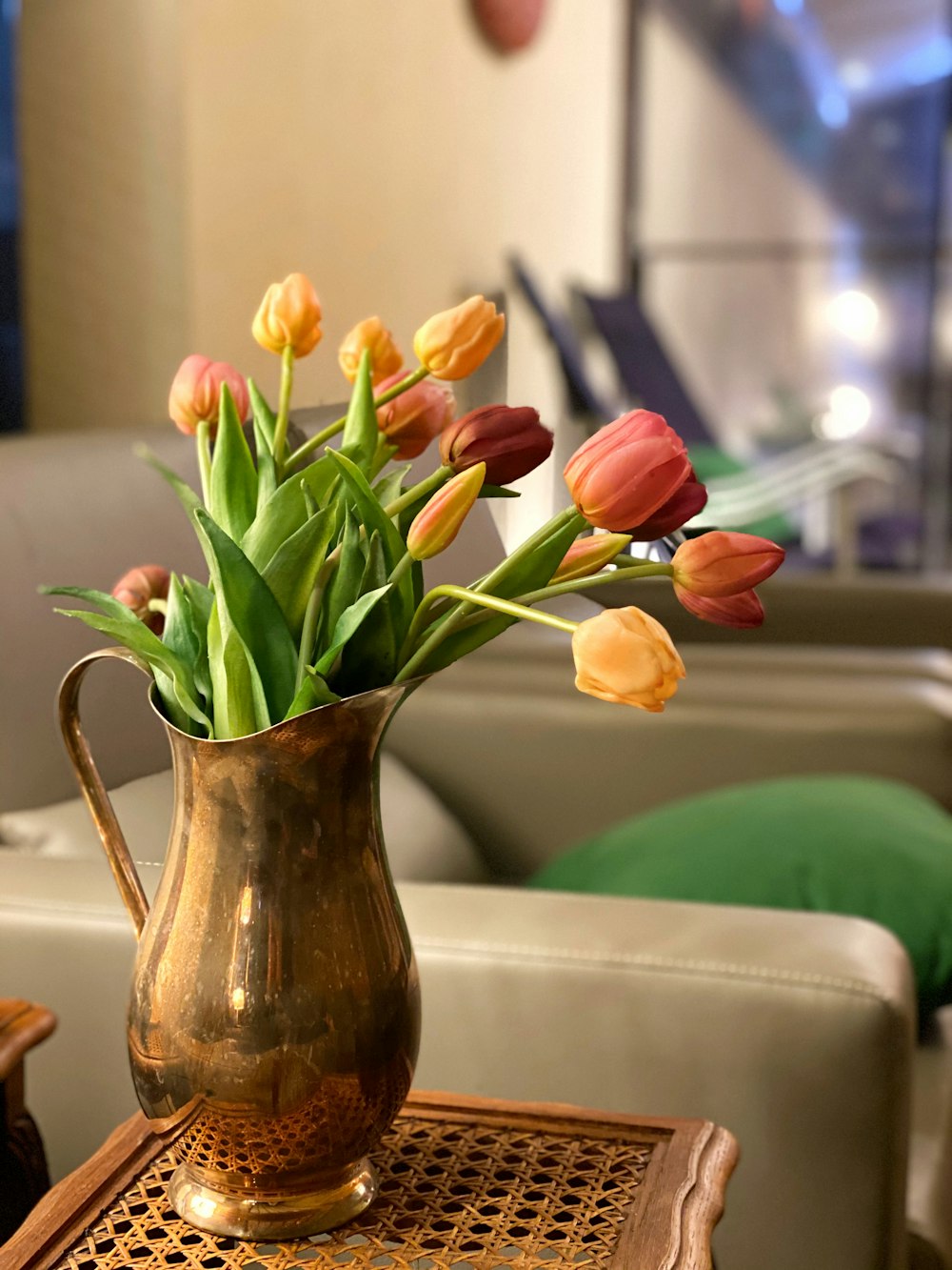 yellow and red tulips in brown ceramic vase