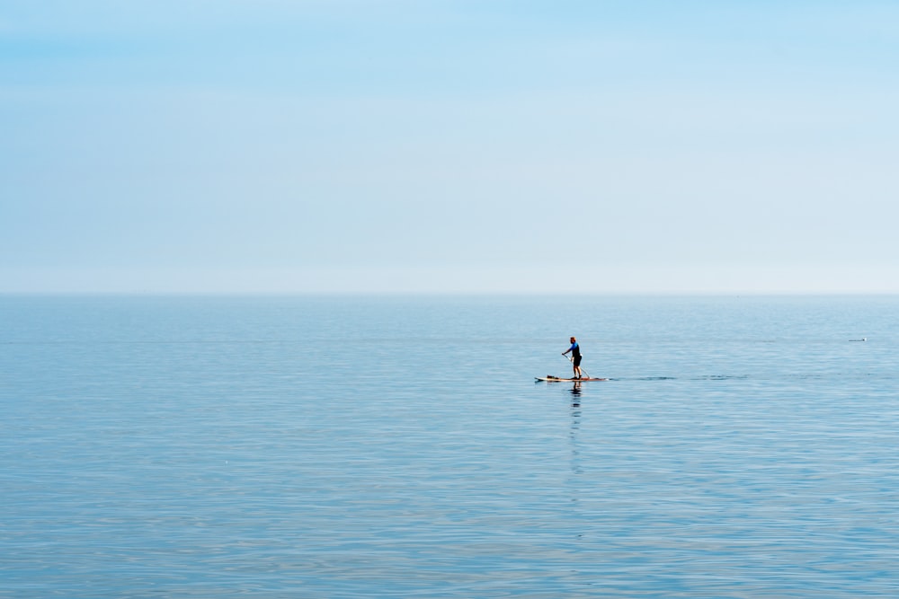 2 person riding on boat on sea during daytime