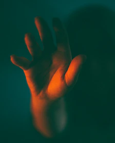 Close-up of a hand reaching to open a futuristic door with glowing edges