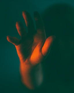 Close-up of a hand reaching to open a futuristic door with glowing edges