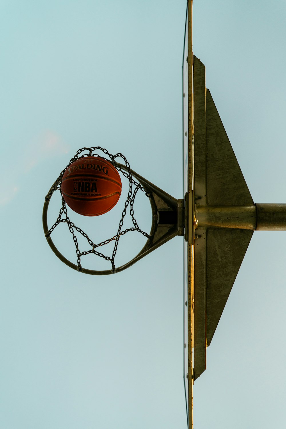 basketball on basketball hoop under blue sky during daytime