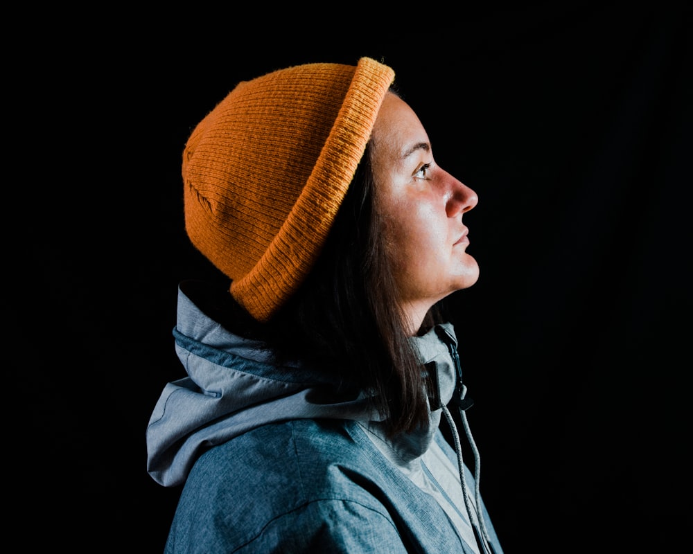 woman in orange knit cap and blue jacket