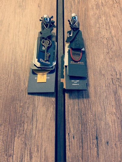 A selection of sleek, minimalist doorbells and keychains arranged neatly on a light wooden surface.