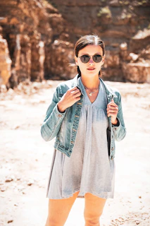 A model wearing a durable, earth-toned western jacket standing in a sunlit field, embodying comfort and style.