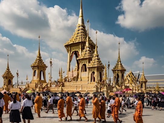 people walking on street near brown concrete building during daytime in Sanam Luang Thailand